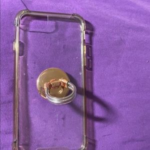 A clear case with a rose gold pop socket